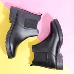 Load image into Gallery viewer, Black leather Block Heeled Chelsea Boots with elastic side panels and chunky soles against pink and yellow background